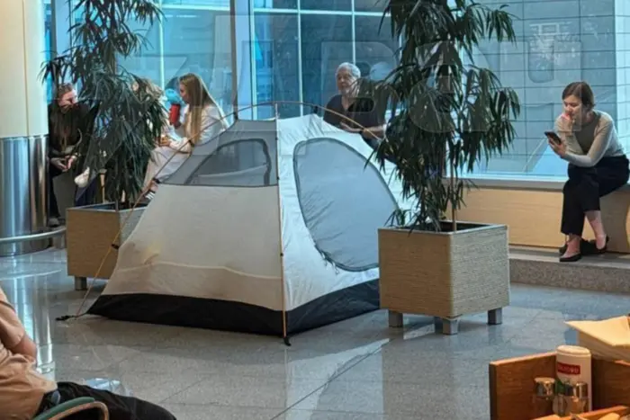 Passengers sleeping on the floor of the airport